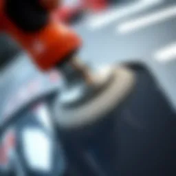 Close-up view of a buffing tool on automotive paint